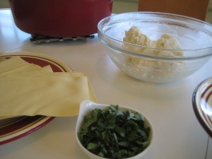 Ingredients to be layered in lasagna:  noodles, basil, and ricotta mixture